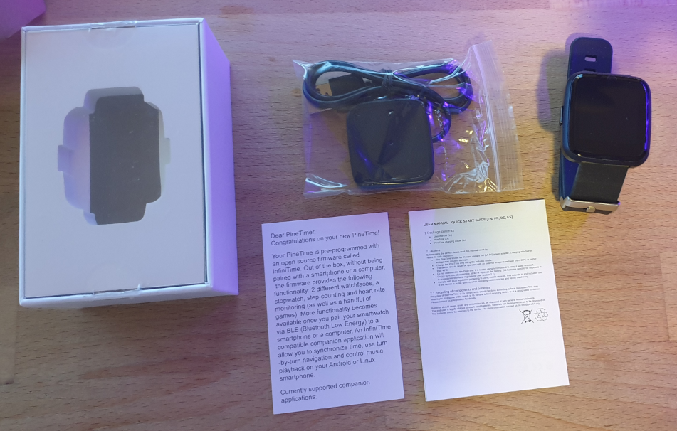 Content of the box, charger, watch and user guides.
